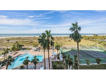 Aerial view featuring a pool, hot tub, and tennis courts with beach access and stunning ocean views at 1230 Gulf Blvd # 604, Clearwater Beach, FL 33767