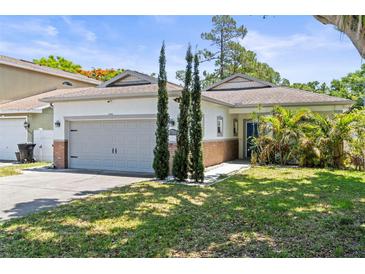 Charming single-story home featuring an attached garage, blue entry door, and well-manicured front lawn at 3611 19Th N St, St Petersburg, FL 33713