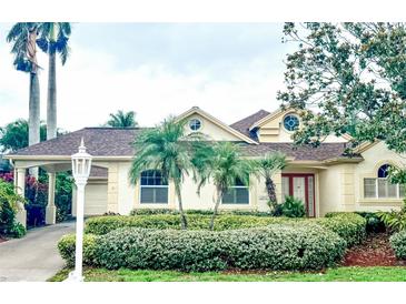 Charming single-Gathering home featuring manicured landscaping, a porte-cochere, and a welcoming facade at 4531 Swordfish Dr, Bradenton, FL 34208