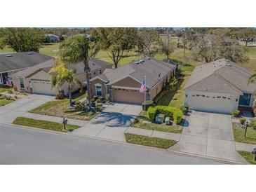 Charming single-story home with well-manicured landscaping and a two-car garage at 18829 Water Lily Ln, Hudson, FL 34667