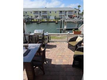 Cozy waterfront patio with a grill and seating, perfect for outdoor entertaining and enjoying scenic views at 5215 Coquina Key Se Dr # A, St Petersburg, FL 33705