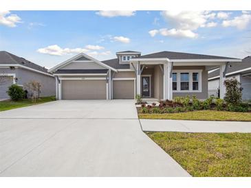 Beautiful single-Gathering home featuring a three-car garage and well-maintained landscaping at 6123 Hidden Branch Dr, Apollo Beach, FL 33572
