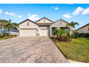 Charming single-Gathering home featuring a paved driveway and two-car garage at 19891 Bridgetown Loop, Venice, FL 34293