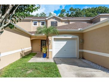 Inviting townhouse featuring a one car garage, neutral paint, and well-maintained landscaping at 8907 Casablanca Way, Tampa, FL 33626