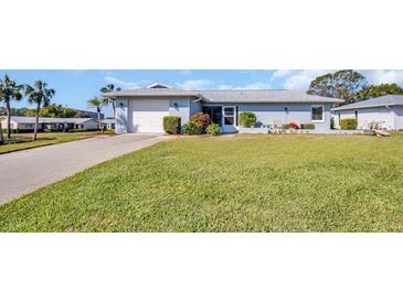 Charming one-story home with a well-maintained lawn and a single-car garage at 1613 Heather Pl, Palm Harbor, FL 34684