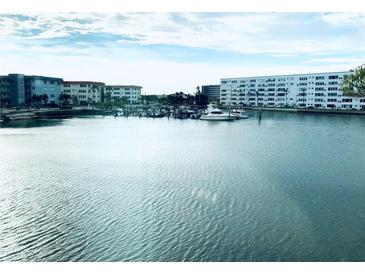 Scenic waterfront view featuring building complex and boat docks against blue skies and tranquil waters at 5940 30Th S Ave # 209, Gulfport, FL 33707