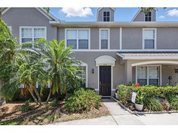 Beautiful townhome exterior with lush tropical landscaping, well-manicured walkway, and inviting front entrance at 8856 Christie Dr # 0, Largo, FL 33771