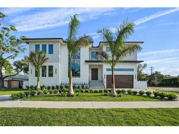 Beautiful two-story house featuring modern design, lush lawn, and professional landscaping at 5038 W Dickens Ave, Tampa, FL 33629