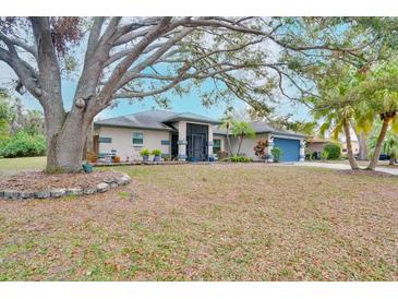 Charming single-story home featuring mature trees, a well-manicured lawn, and a welcoming entrance at 4553 31St E Ct, Bradenton, FL 34203