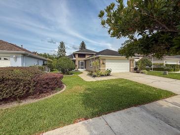 Charming single-story home with a well-manicured lawn, driveway, and attached garage, perfect for suburban living at 1604 Boswell Ln, New Port Richey, FL 34655