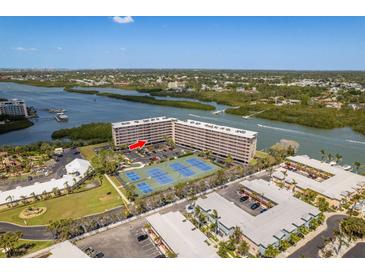 Waterfront condo with tennis courts, beautiful river views, and lush landscaping create a resort-like atmosphere at 19451 Gulf Blvd # 204, Indian Shores, FL 33785