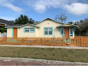 Charming bungalow with a colorful picket fence and vibrant trim, creating a welcoming curb appeal at 331 25Th S St, St Petersburg, FL 33712