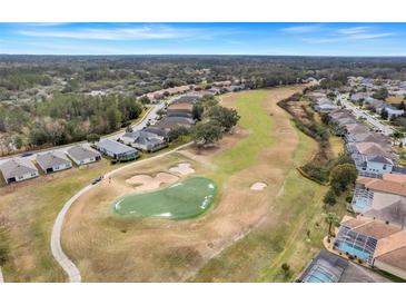 Scenic aerial view of the community golf course with lush green fairways and well-maintained landscaping at 4605 Lisette Cir, Brooksville, FL 34604
