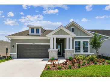Charming single-Gathering home with a two-car garage and beautifully landscaped front yard at 5289 Everlong Dr, Apollo Beach, FL 33572