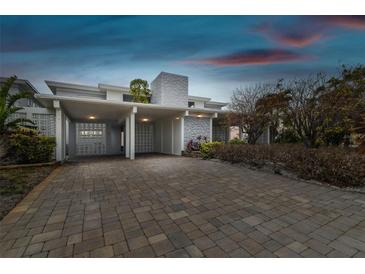 Charming single Gathering home with a two-car carport featuring a stylish brick driveway and unique facade at 800 Madonna Blvd # 2, Tierra Verde, FL 33715