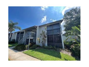 Two-story condo with charming stairs leading to the second floor and a well-manicured lawn at 11201 122Nd Ave # 204, Largo, FL 33778