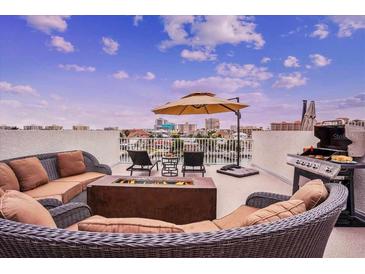 Relaxing rooftop deck with comfortable seating, a fire pit, grill, and stunning city views at 145 Brightwater Dr # 2, Clearwater, FL 33767