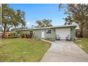 Charming single-story home with a well-maintained lawn and inviting curb appeal at 1415 Ridge Ave, Clearwater, FL 33755