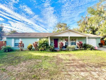 Charming single-story home with well-maintained landscaping, inviting curb appeal, and a delightful covered porch at 37634 Hidden Park Ct, Dade City, FL 33525