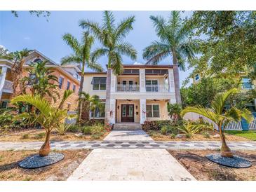 Stunning two-story home with a welcoming front porch and lush tropical landscaping at 310 8Th N Ave, St Petersburg, FL 33701