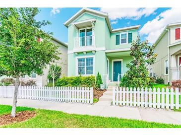 Charming two-story home with a picket fence and a well-manicured front yard at 11125 Winthrop Lake Dr, Riverview, FL 33578