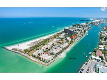 Stunning aerial view of beachfront condos on Treasure Island with boat docks and beach access at 7537 Bayshore Dr # 406, Treasure Island, FL 33706
