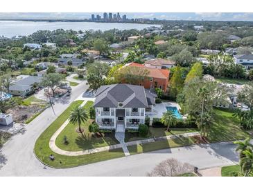 A beautiful home with a pool is seen from above, with a water view and a clear view of the city skyline at 200 Cordova Ne Blvd, St Petersburg, FL 33704