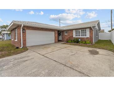 Charming single-story brick home featuring an attached garage and a well-maintained front yard at 6950 113Th St, Seminole, FL 33772