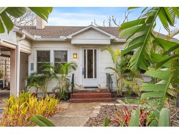 Charming home featuring a brick entryway and lush tropical landscaping adding curb appeal at 17 Venetian Ct, Tarpon Springs, FL 34689