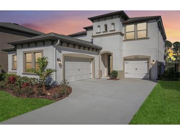 Charming two-story home with a spacious driveway, three-car garage, and well-maintained landscaping at 14838 Paddock Pond Ave, Lithia, FL 33547