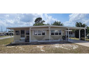 Charming single-story home with a covered porch and carport, providing convenient outdoor space and parking at 35138 Dale Ave, Zephyrhills, FL 33541