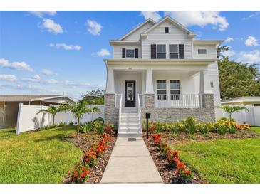 Charming two-story home featuring a beautifully landscaped front yard with a welcoming walkway at 441 42Nd Ne Ave, St Petersburg, FL 33703