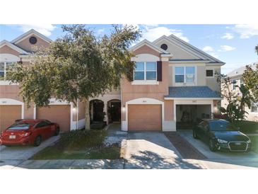 Charming two-story townhome with a one-car garage, landscaped front yard, and welcoming curb appeal at 26614 Castleview Way, Wesley Chapel, FL 33544