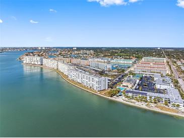 Expansive aerial view of waterfront condos and a marina on a sunny day with blue sky and sea at 3010 59Th S St # 304, Gulfport, FL 33707