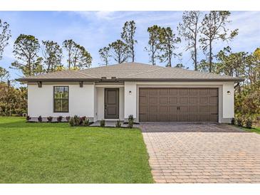 Charming single-story home boasting a manicured lawn, two-car garage and neutral color palette at 3378 Escobar Ln, North Port, FL 34286