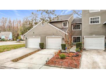 Charming multi-unit home with well-maintained landscaping, white garage doors, and a neutral exterior color at 5832 Red Cedar Ln, Tampa, FL 33625