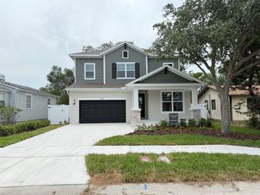 Charming two-story home with landscaped yard, covered porch and a black two car garage at 3218 21St N St, St Petersburg, FL 33713
