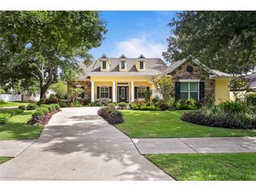 Charming home featuring manicured landscaping, stone accents, and a welcoming front porch at 4023 W Horatio St, Tampa, FL 33609