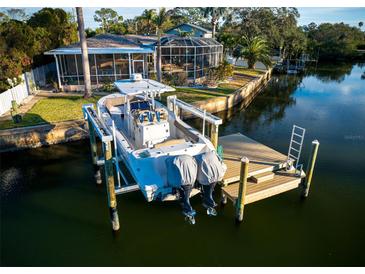 Stunning waterfront home with a private dock and boat lift, perfect for enjoying waterfront living at 3998 South Cir, Largo, FL 33774