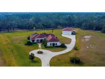 Expansive home and large detached garage, with circle drive on a well-manicured acreage at 6367 Foxbrook Trl, Parrish, FL 34219