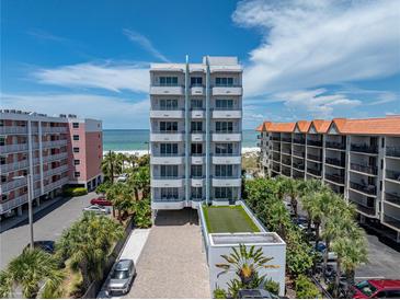 Stunning high-rise condominium with balconies overlooking the beach and blue skies at 3910 Gulf Blvd # 400, St Pete Beach, FL 33706