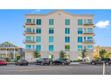 Modern six story condo building with balconies, manicured landscaping, and street parking at 644 3Rd S Ave # 305, St Petersburg, FL 33701