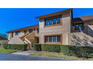 Inviting two-story condo featuring updated windows, a private balcony and mature landscaping at 8005 Bardmoor Pl # 202I, Seminole, FL 33777