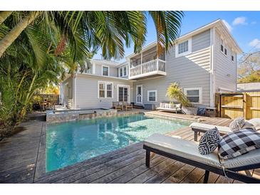Relaxing backyard pool with tropical landscaping and wooden deck offers a perfect outdoor retreat at 425 20Th Ne Ave, St Petersburg, FL 33704