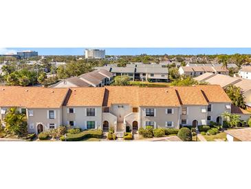 Attractive condo featuring a tile roof, well-maintained landscaping, and inviting curb appeal at 13600 Egret Blvd # 204K, Clearwater, FL 33762