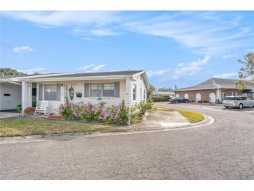 Lovely single-story home featuring well-kept landscaping and covered entrance at 5006 Springwood N Ave # 119, Pinellas Park, FL 33782