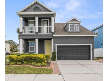 Charming two-story home features a welcoming porch, manicured lawn and attached two-car garage at 7602 S Desoto St, Tampa, FL 33616