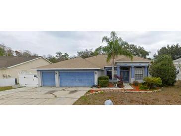 Charming single-story home with a well-maintained lawn and a two-car garage at 1530 Davenport Dr, New Port Richey, FL 34655