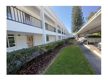Two-story condo with covered parking, landscaping, and well-maintained grounds at 2060 Marilyn St # 133, Clearwater, FL 33765