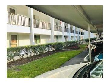 Exterior view of building with lawn and covered parking at 2060 Marilyn St # 133, Clearwater, FL 33765